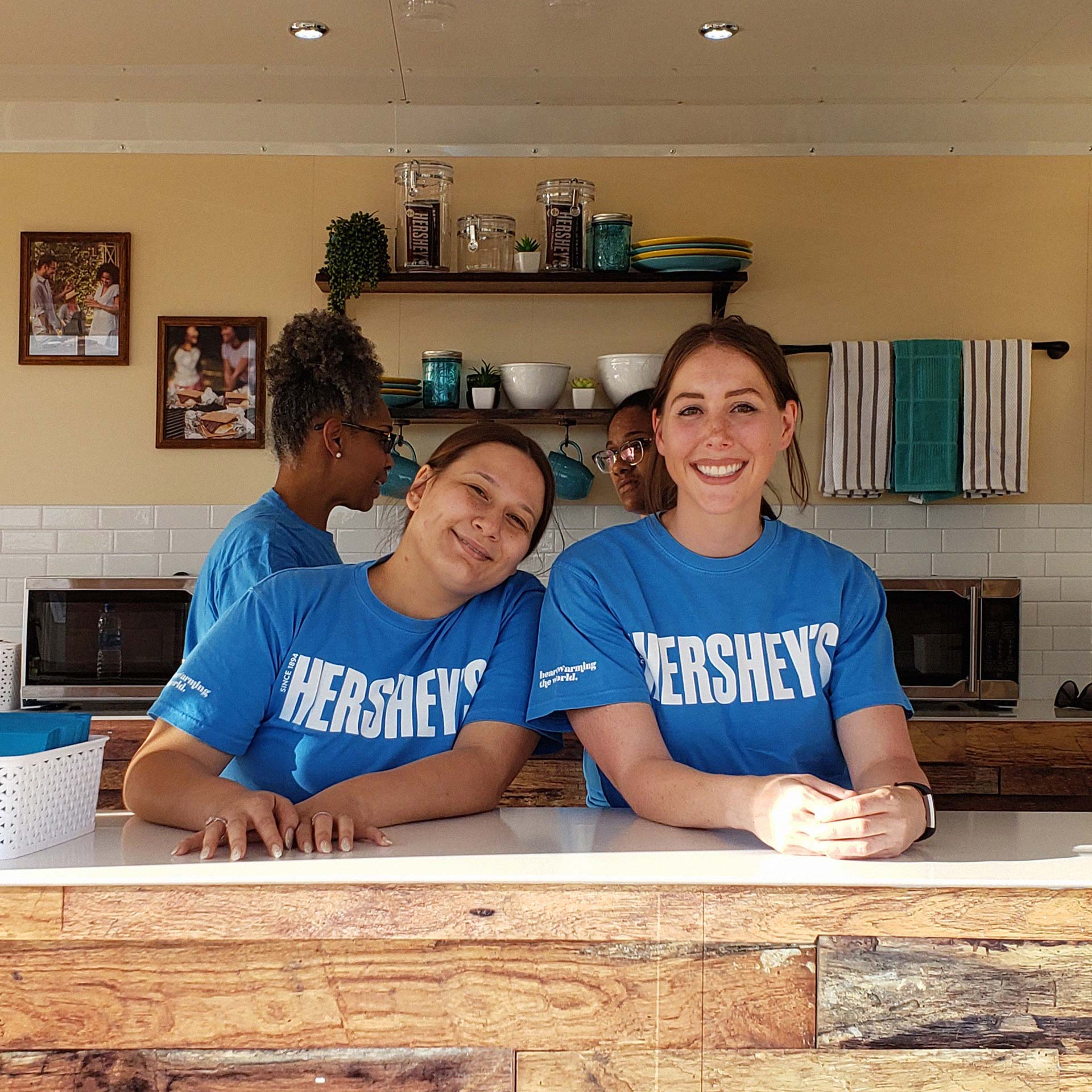 Two female Hershey's brand ambassadors smiling behind the counter