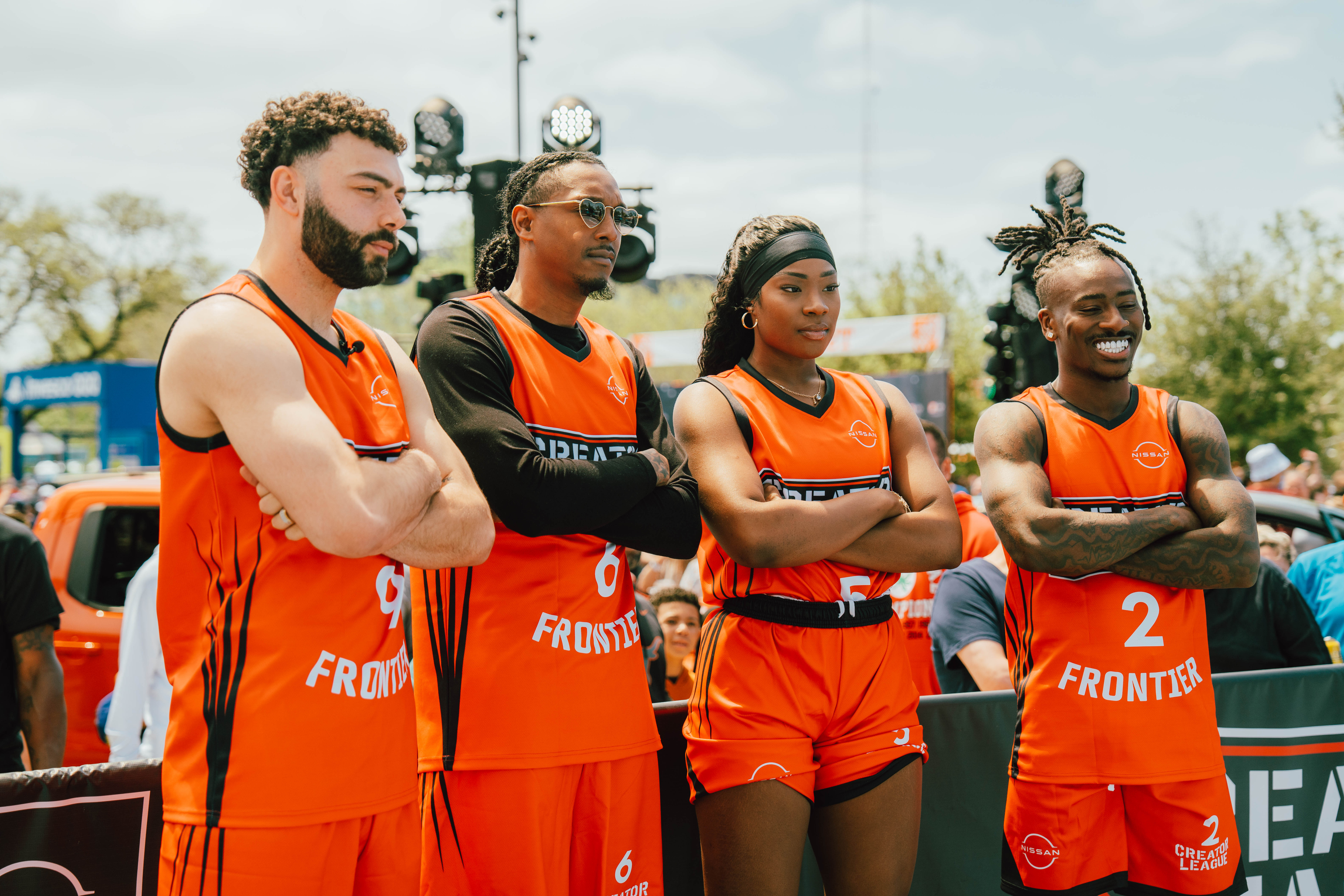 Four creators posing for group photo in basketball gear.