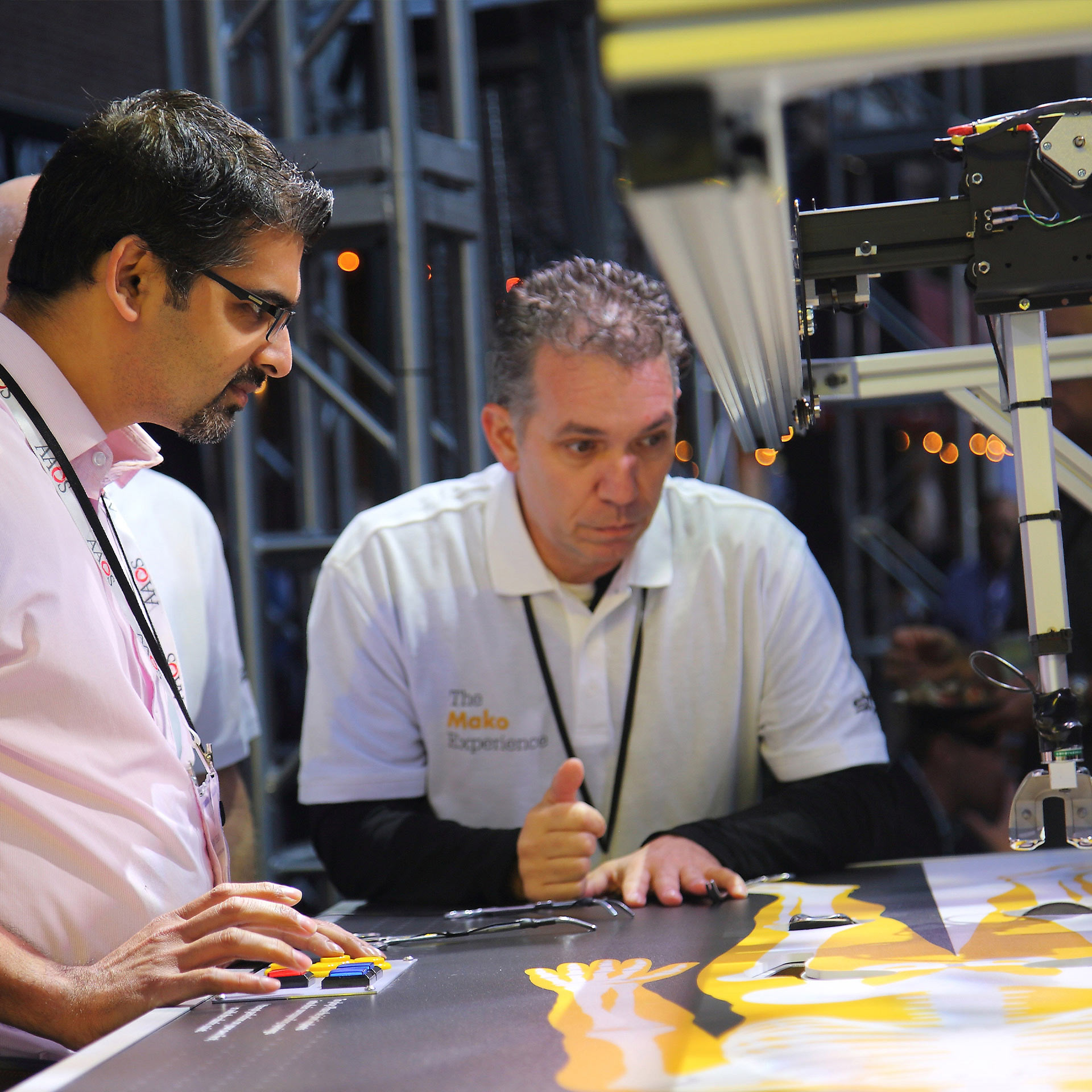 A Stryker brand ambassador guides an attendee as they plan out a hypothetical surgery. 